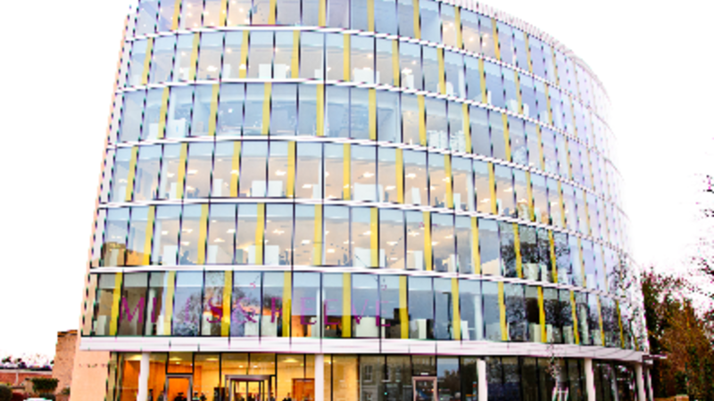 MOdern, curved building against clear background